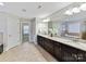 Elegant bathroom boasts a long vanity with double sinks and granite countertops, plus a soaking tub at 4624 Pebble Run Dr, Matthews, NC 28105