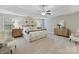 Spacious main bedroom with tray ceilings, ceiling fan, ensuite bath access, and sitting area at 4624 Pebble Run Dr, Matthews, NC 28105