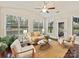 Sunroom with hardwood floors, neutral furniture, and plenty of natural light at 4624 Pebble Run Dr, Matthews, NC 28105