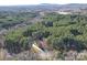 Expansive aerial view of a secluded home surrounded by lush green forests, offering privacy and natural beauty at 4763 River Hills Dr, Denver, NC 28037