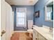 Charming bathroom featuring blue walls, a shower with a curtain, and a white vanity at 4763 River Hills Dr, Denver, NC 28037