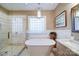 Relaxing bathroom showcasing a soaking tub, walk-in shower, and vanity with granite counters at 4763 River Hills Dr, Denver, NC 28037