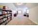 Spacious bonus room with carpet, built-in bookshelves, and a comfortable seating area at 4763 River Hills Dr, Denver, NC 28037
