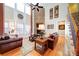 Spacious living room with a stone fireplace, hardwood floors, and ample natural light at 4763 River Hills Dr, Denver, NC 28037