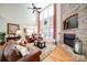 Inviting living room with a stone fireplace, hardwood floors, and abundant natural light at 4763 River Hills Dr, Denver, NC 28037