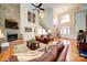 Elegant living room with a cozy fireplace, hardwood floors, and plenty of seating at 4763 River Hills Dr, Denver, NC 28037