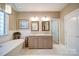 Luxurious main bathroom featuring a soaking tub, double vanity, and modern lighting at 4763 River Hills Dr, Denver, NC 28037