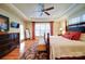 Bright main bedroom features hardwood floors, large windows, and stylish decor at 4763 River Hills Dr, Denver, NC 28037