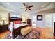 Elegant main bedroom with tray ceiling, hardwood floors, and ensuite bathroom access at 4763 River Hills Dr, Denver, NC 28037