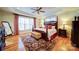 Stunning main bedroom with tray ceiling, hardwood floors, and sitting area at 4763 River Hills Dr, Denver, NC 28037