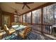 Screened patio with outdoor dining set, wood flooring, and ceiling fans at 4763 River Hills Dr, Denver, NC 28037