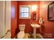 Charming powder room features a pedestal sink, tiled floors, and fresh paint at 4763 River Hills Dr, Denver, NC 28037