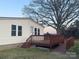 A ranch style home with white siding, a brown deck, and a ramp leading up to the deck at 485 Harper Miller Dr, Cleveland, NC 27013