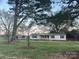 Exterior view of a white house with blue shutters, a covered porch, and well-maintained lawn surrounded by mature trees at 485 Harper Miller Dr, Cleveland, NC 27013