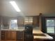 A traditional kitchen with a black range, laminate countertop, and wood cabinets at 485 Harper Miller Dr, Cleveland, NC 27013