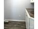 A laundry room with wood-look vinyl flooring and white cabinets with a counter top at 485 Harper Miller Dr, Cleveland, NC 27013
