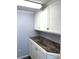 Laundry room featuring white cabinets, laminate countertop, and beadboard details at 485 Harper Miller Dr, Cleveland, NC 27013