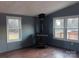 Living room featuring a wood-burning stove, laminate flooring, and bright windows at 485 Harper Miller Dr, Cleveland, NC 27013
