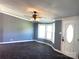 Bright living room featuring plush carpet, a ceiling fan with light, and a bay window at 485 Harper Miller Dr, Cleveland, NC 27013