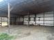 An outbuilding with a metal roof and open sides filled with equipment at 485 Harper Miller Dr, Cleveland, NC 27013