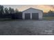 A large metal outbuilding with two garage doors and an awning in front at 485 Harper Miller Dr, Cleveland, NC 27013
