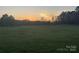Expansive view of the property showcasing its natural beauty and spaciousness at sunset at 485 Harper Miller Dr, Cleveland, NC 27013