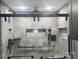 Close-up of walk-in shower with gray tile, a shower seat, and modern fixtures at 485 Harper Miller Dr, Cleveland, NC 27013