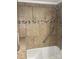 Shower-tub combo featuring brown tile with decorative border and a handheld shower at 485 Harper Miller Dr, Cleveland, NC 27013