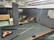 Finished basement featuring a billiards area, and comfortable seating for entertainment at 5057 Murrayhill Rd, Charlotte, NC 28210