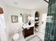 Stylish bathroom features a wood vanity, decorative mirror, tile floors and tiled shower at 5057 Murrayhill Rd, Charlotte, NC 28210