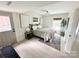 Cozy bedroom with neutral color palette, two windows, and door to the backyard at 5057 Murrayhill Rd, Charlotte, NC 28210