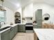 Updated kitchen features green cabinetry, marble counters, floating shelves and stainless steel appliances at 5057 Murrayhill Rd, Charlotte, NC 28210