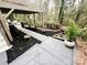 Stone walkway leads to the backyard deck, surrounded by lush landscaping at 5057 Murrayhill Rd, Charlotte, NC 28210