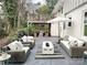 Back patio featuring comfortable seating, a modern fire pit, and an upper level deck at 5057 Murrayhill Rd, Charlotte, NC 28210