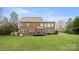 Beautiful brick home featuring a well-maintained lawn and a cozy deck, offering a serene outdoor space at 518 Streamside Ln, Marvin, NC 28173
