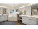 Bright bathroom featuring a soaking tub, a makeup vanity, and grey cabinets at 518 Streamside Ln, Marvin, NC 28173