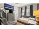 Bedroom featuring a bed, dresser, and a wall-mounted TV beneath a Patagonia flag at 518 Streamside Ln, Marvin, NC 28173