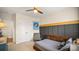 Comfortable bedroom with a bed, chair, closet, and a decorative wall accent at 518 Streamside Ln, Marvin, NC 28173