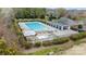 Aerial view of a sparkling community pool with a clubhouse, creating a perfect recreational area at 518 Streamside Ln, Marvin, NC 28173