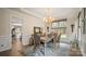 Elegant dining room features hardwood floors, a stylish chandelier, and abundant natural light at 518 Streamside Ln, Marvin, NC 28173