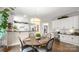 Cozy dining area features a round table, stylish chairs, and an open connection to the kitchen at 518 Streamside Ln, Marvin, NC 28173