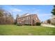 Elegant brick home with a well-manicured lawn and a charming deck, showcasing classic curb appeal at 518 Streamside Ln, Marvin, NC 28173
