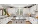 Well-equipped kitchen with a center island, granite countertops, and pristine white cabinetry at 518 Streamside Ln, Marvin, NC 28173