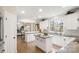 Open-concept kitchen boasts white cabinets, granite countertops, stainless steel appliances, and center island at 518 Streamside Ln, Marvin, NC 28173