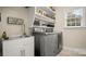 Laundry room with stainless steel washer, dryer and utility sink at 518 Streamside Ln, Marvin, NC 28173