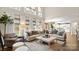 Sunlit living room with large sectional sofa and view into kitchen area at 518 Streamside Ln, Waxhaw, NC 28173