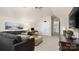 Bright living room with vaulted ceilings, a gray sectional, and an office area at 518 Streamside Ln, Marvin, NC 28173