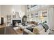 Grand living room featuring a fireplace, plush seating, and soaring ceilings with natural light at 518 Streamside Ln, Marvin, NC 28173