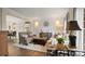 Stylish living room with hardwood floors, classic wainscoting, neutral furniture, and an open view to the dining area at 518 Streamside Ln, Marvin, NC 28173