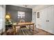 Cozy home office featuring a dark accent wall, wooden desk, and a decorative rug creating a perfect workspace at 518 Streamside Ln, Marvin, NC 28173